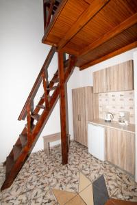 a kitchen with a wooden staircase in a room at Sweet Heart Studios in Kamari