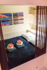 a bedroom with a bed with two pillows on it at Alana Care Bed & Breakfast in Tonden