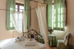 Postel nebo postele na pokoji v ubytování Agriturismo Podere La Rocca
