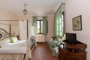 Postel nebo postele na pokoji v ubytování Agriturismo Podere La Rocca