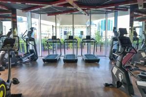 a gym with treadmills and elliptical machines at Miraclz Skyline Tower in Dubai