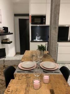 una mesa de madera con platos y copas de vino. en Namur à Mur en Namur