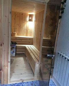 a wooden sauna with a shower in a room at BANJA SVETA NEDELA in Katlanovo