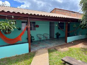 a house with a hammock in front of it at Casa Esmeralda in Alto Paraíso de Goiás