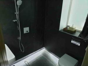 bagno nero con doccia e servizi igienici di Luxury Barn Conversion at Rudding a Harrogate