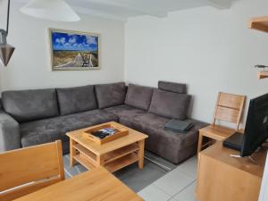a living room with a couch and a table at Fewo "Marienleuchte" in Bannesdorf auf Fehmarn in Fehmarn