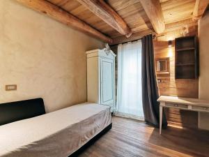 a bedroom with a bed and a window at Ca' Maira Casa di montagna in Val Maira con vista in Roccabruna