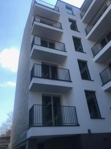 a white building with balconies on it at Apartament Miodowa 42 z miejscem parkingowym in Krakow