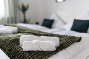 two white towels sitting on top of two beds at Apart63-Modern-3Room I Smart TV I Free Parking I Free WiFi in Hamm