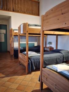 a room with three bunk beds in a house at Ostello Europa in San Vito al Tagliamento