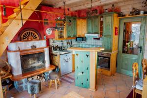 a kitchen with green cabinets and a stove at Chalet Alpinka in Cerklje na Gorenjskem