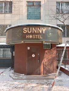 a small building with a sign that reads sunny hospital at Уютный Sunny hostel in Almaty