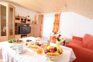 a table with a basket of fruit on it at Bauernhof Strieder in Maria Luggau