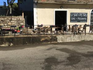 a group of tables and chairs outside of a restaurant at Chambre avec balcon à louer in Bains de Guitera