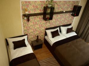 a bedroom with two beds and a wall at Leon Hotel in Lviv