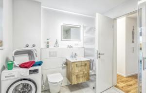 a white bathroom with a washing machine and a sink at Awesome Home In Tossens With Kitchen in Tossenserdeich