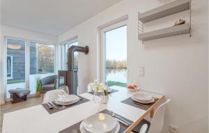 a kitchen and dining room with a table and chairs at Awesome Home In Tossens With Kitchen in Tossenserdeich
