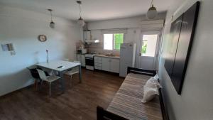 a kitchen and dining room with a table and a refrigerator at Depto calle 18 - soleado y con balcon in La Plata