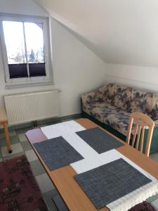 a living room with a table and a couch at Appartment Isabelle Sky in Presseggersee