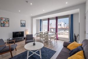 a living room with a couch and a table at Modern Penthouse with Private Terrace in Valencia