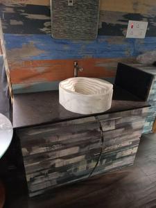 a counter with a white bowl on top of it at Fancy and Modern Apartment in Patna