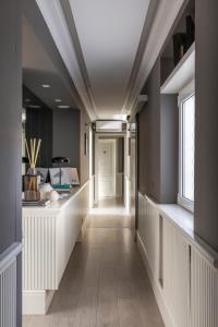 a hallway with a long corridor with white walls at NAMAN HOTELLERIE - Spagna in Rome