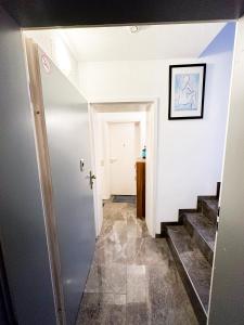 a hallway with a door and stairs in a house at Downtown Apartments Theatre in Baden-Baden