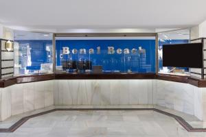 a lobby with a large window with a sign that reads rental beach at Apartamento con vistas al mar in Benalmádena +46 photos