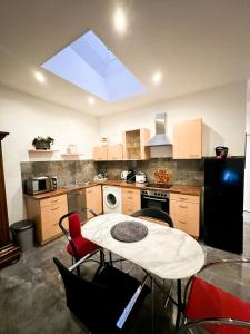 a kitchen with a table and chairs in it at Downtown Apartments Theatre in Baden-Baden