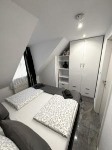 ein Schlafzimmer mit zwei Betten und einem Kleiderschrank in der Unterkunft Downtown Apartments Theatre in Baden-Baden