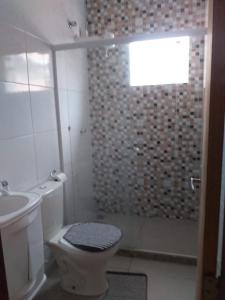 a bathroom with a shower and a toilet and a sink at Dom Gabriel 4 in Campos dos Goytacazes