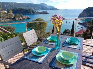 a table with a view of the ocean at Sea La Vie Apt. in Paleokastritsa