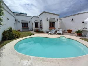 a large swimming pool in front of a house at Hotel Del Virrey in Salta