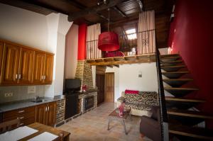 a living room with a spiral staircase in a house at Apartamentos El Sualleiro in Santa Eulalia de Oscos