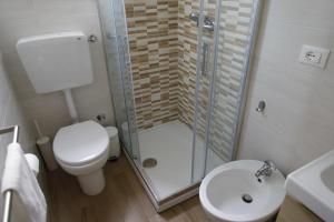 a bathroom with a shower and a toilet and a sink at Cannotta Beach - Alicudi in Terme Vigliatore