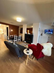a living room with a couch and a table at Renovated Apartment 5 min to Crans Montana Center in Crans-Montana