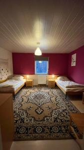a room with two beds and a rug at Monteure, ganzes Haus, Schwarzheide, Haus 1 in Schwarzheide
