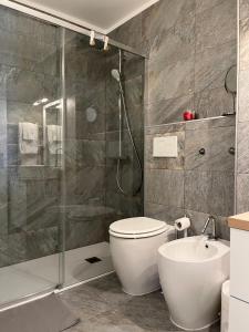 a bathroom with a shower and a toilet and a sink at Renovated Apartment 5 min to Crans Montana Center in Crans-Montana