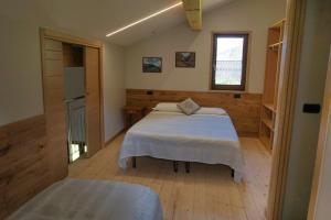 a bedroom with a bed and a window at Albergo Diffuso Ceaglio Valle Maira in Marmora