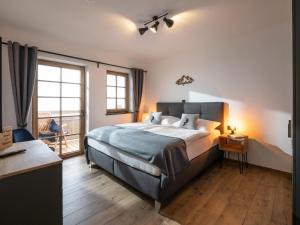 a bedroom with a large bed and a window at Alpenliebe Zillertal in Hart im Zillertal