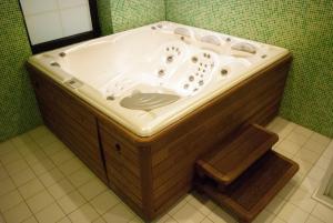 a bath tub with a sink in a bathroom at Apartmány Cestář Boží Dar in Boží Dar