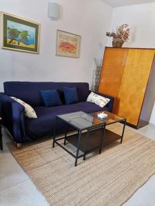 a living room with a blue couch and a table at House Marineta - Makarska promenade in Makarska