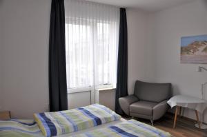 Ένα ή περισσότερα κρεβάτια σε δωμάτιο στο Ferienhaus Nordstrand Whg 2