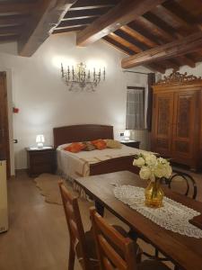 a bedroom with a bed and a table with flowers on it at Il Castelletto di Gomo in Godiasco