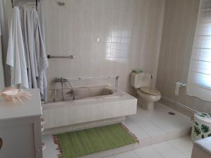 a white bathroom with a tub and a toilet at Berdullas in Vilagarcia de Arousa +27 photos