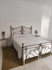 um quarto com uma cama com um edredão branco em A Barunedda - charming house with terrace em Taormina