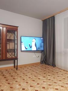 a living room with a flat screen tv on the wall at Apartament u Tomka Premium in Ustrzyki Dolne