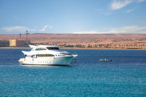 a white boat in the middle of the water at Zen Resort Sahl Hasheesh by TBH Hotels in Hurghada