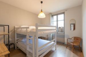 a bedroom with two bunk beds and a window at CABANA & Confort - Proche Centre-Ville , Parking in Tournus