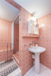 a bathroom with a sink and a shower at Penzion Pod Hrází in Český Krumlov